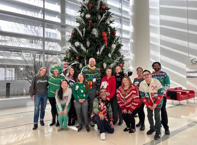Our stroke team posing in front of the Christmas tree in the James.