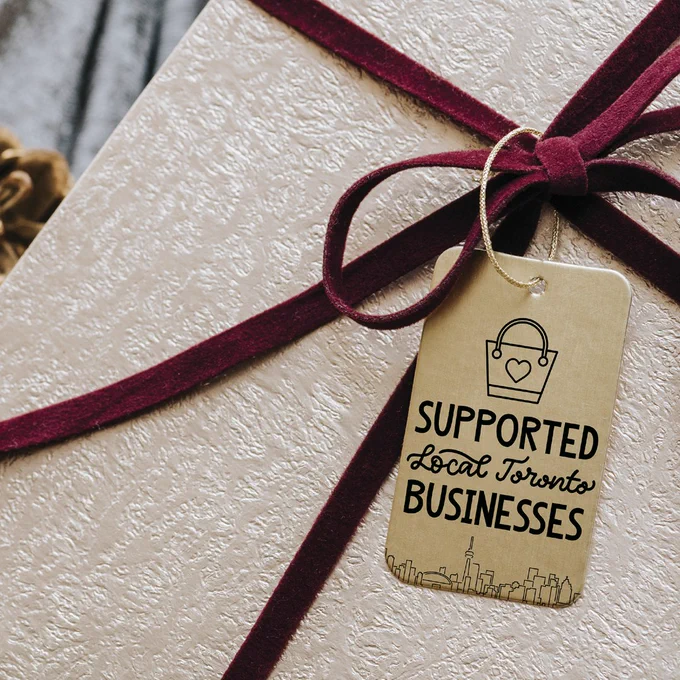 A gift wrapped with a tag that says "Support local Toronto businesses"