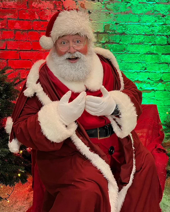 Father Christmas, with a red and green brick background.