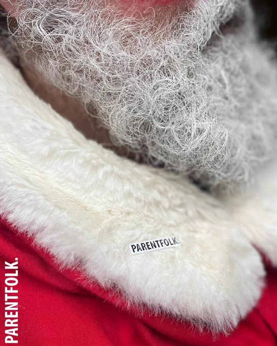 A profile view of Father , Christmas, close-up and beard and collar with a Parentfolk badge.