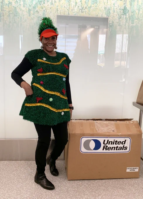 Eunice stands next to a United Rentals box