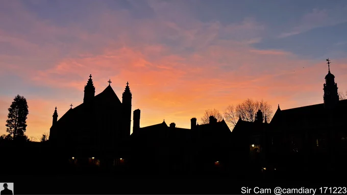 Sunrise at Selwyn College, Cambridge 17 December 2023. College buildings silhouetted against the orange sunrise sky.
