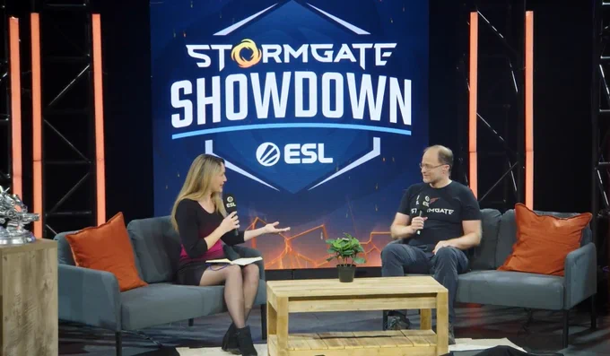 Rachel and Tim Morten talking on stage in front of a StormgateShowdown logo