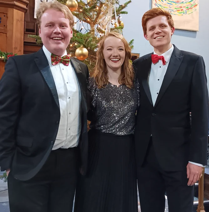 MD Harry Bradford, harpist Alis Huws and tenor Alex Hume, all smiling and in evening dress