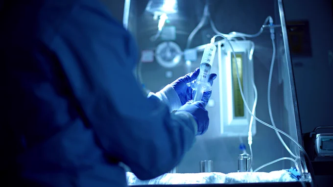 Someone holding a syringe