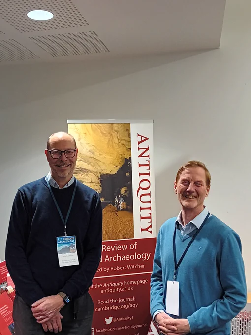 Andy Hutcheson and Robin Skeates in front of an Antiquity banner