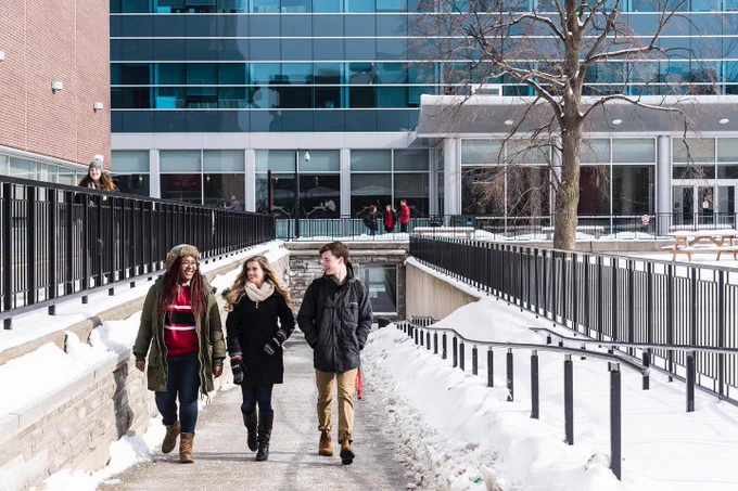 Carleton University Campus with 3 people walking