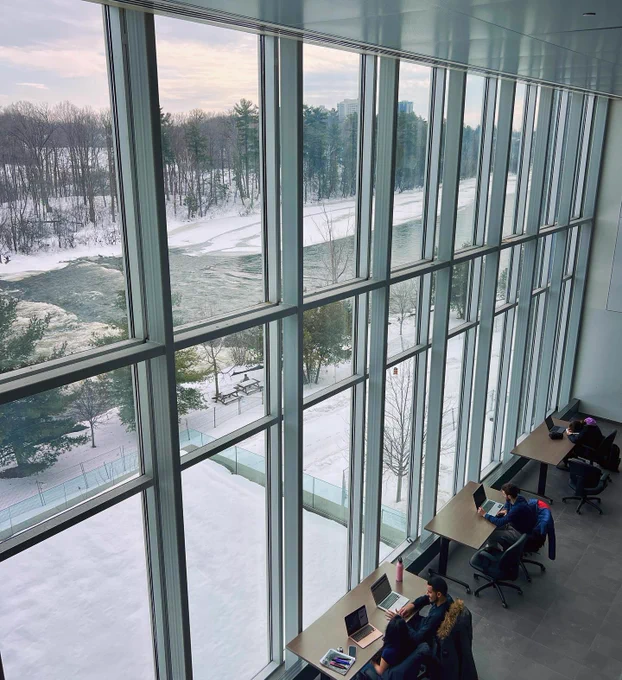 Students working at desk with outside view