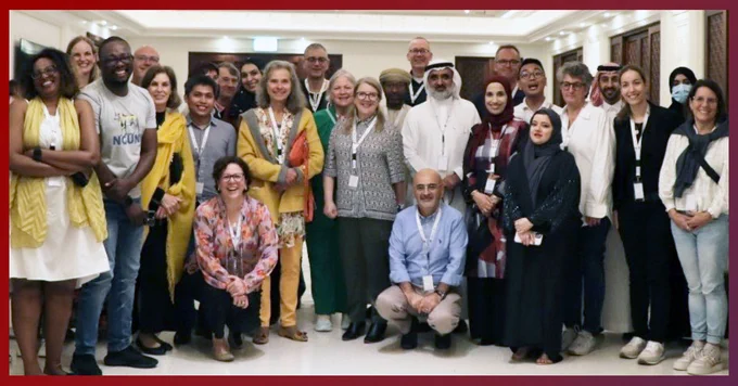 Dr. Barbara Maxwell stands front and center with a group of health care leaders at All Together Better Health XI in Qatar.
