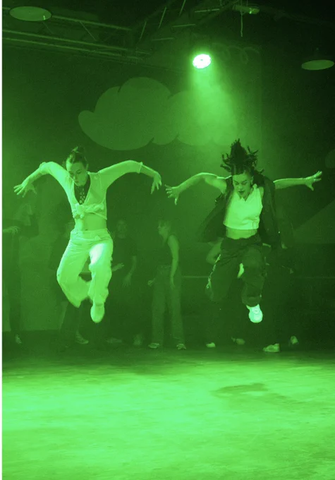 Two people jumping with a green light on them
