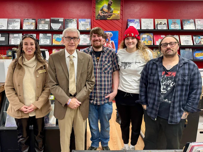 Gov. Evers, Rep. Snodgrass, and small business owners in a record store.