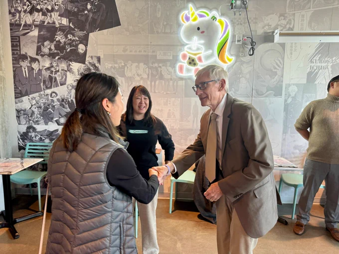 Gov. Evers shakes hands with a small business owner.