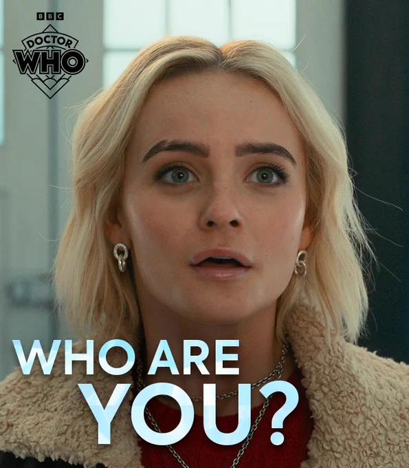 Millie Gibson as Ruby Sunday, looking up in awe at the Doctor, asking "Who are you?"