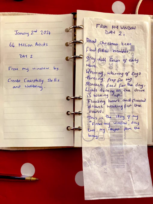 An open ring binder book A6. Left page says “Day 2, from my window  by Create Caerphilly skills and wellbeing. Right page written on the bag of a paper medical syringe saved from the bin is written:  FROM My Window. 
DAY 2.
Dead christmas tree, flood filled baubles, 
grey dull Skies of early morn. 
Whiring, Whiring of cogs turning; prep for day my 
Stomach feed for the day. Lights turning on;  the drive is waking up.
Floating heart and flooded drains,
Waiting for the rains.
“This is the stay of my
"'From My window", day two,                                               My inspo’ from my bay.