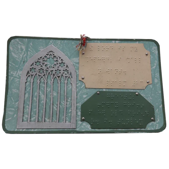 A greeting card with three tactile plates, two are covered in braille. 