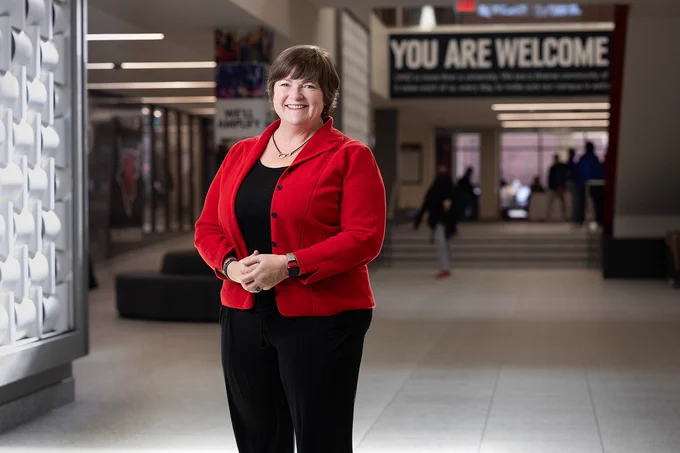 Ann Gentle stands at the atrium of the Milo Bail Student Center