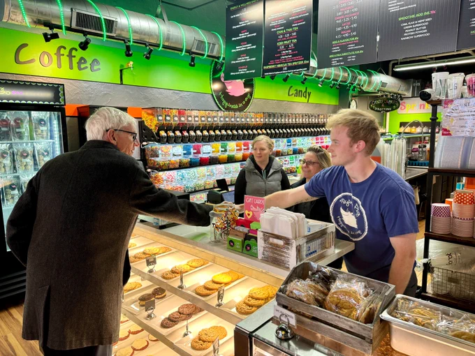 Gov. Evers shakes hands with a worker behind a counter.