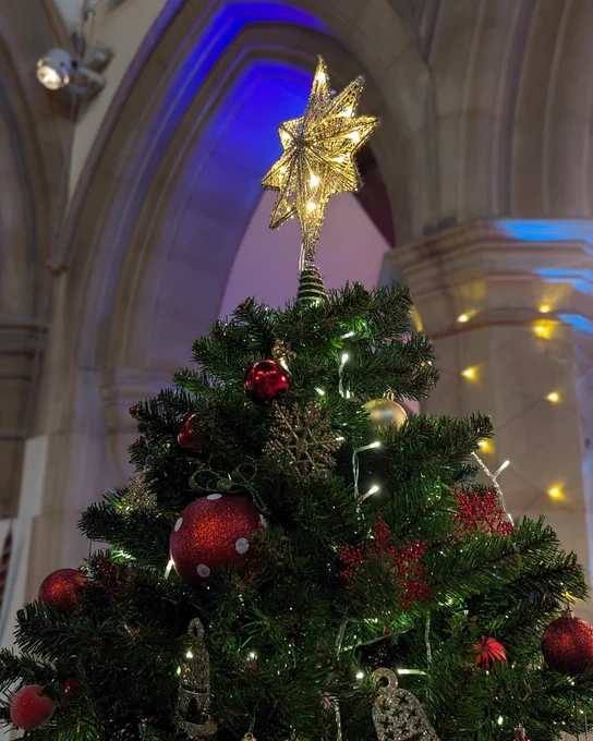 Close up of a star on top of a Christmas tree.