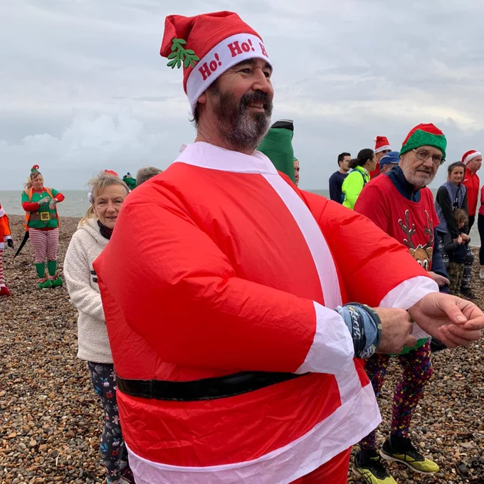 Man dressed up in santa suit at parkrun