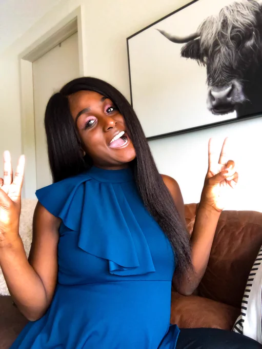 Black woman with long hair in blue blouse playfully smiling with peace signs. The Leasing Masters’ Founder