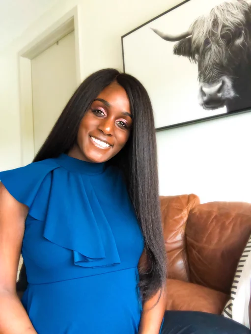 Black woman with long hair in blue blouse smiling. The Leasing Masters’ Founder