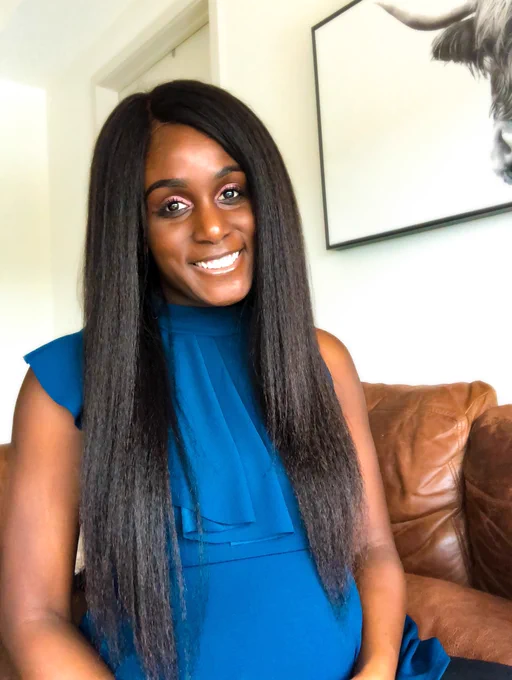 Black woman with long hair in blue blouse smiling. The Leasing Masters’ Founder