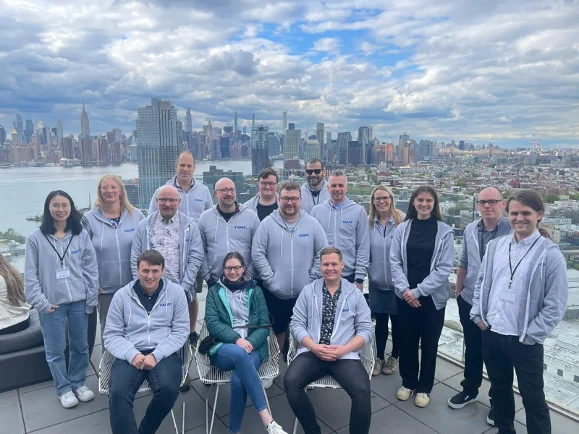 The incredible structural biology team from ASAP standing in front of the NYC skyline wearing hoodies featuring the ASAP logo.