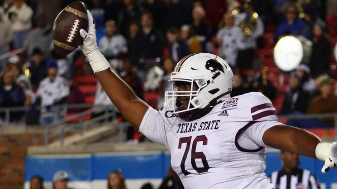 TXST football player celebrates