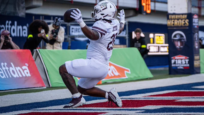 TXST football player celebrates
