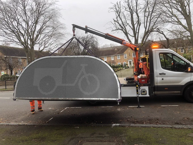 A @cyclehoop van off loading a cargo/adapted cycle hangar onto the street somewhere in Westminster.