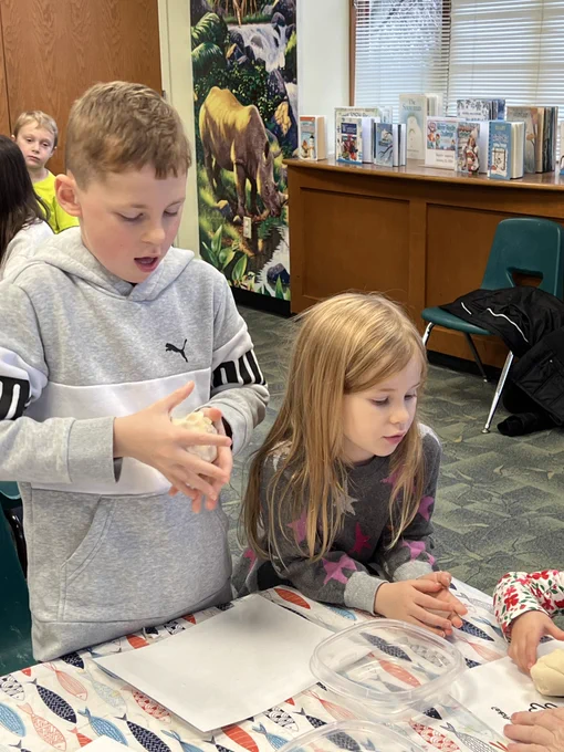 Boy and girl doing crafts in library