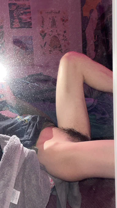 i'm sitting on the edge of a chair leaned back with my legs resting on my desk (which isn't visible). One leg is bent up and the one closer in the pic is bent straight. This pose shows off my strong thighs, ass, and some calf. It also shows my thick bush and my happy trail is just barely visible.