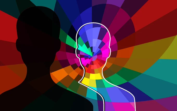 image with silhouettes of two people -- one black silhouette and one with rainbow mosaic background