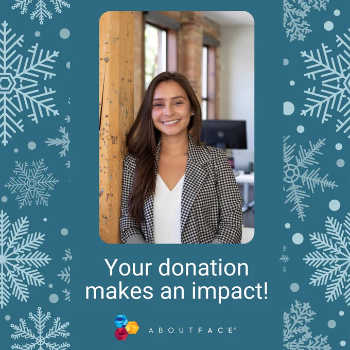 blue background with white snowflakes. There is a photo of a woman with a birthmark in the middle with white text below that reads "your donation makes an impact" with the AboutFace logo below.