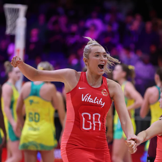 Helen Housby runs towards the team to celebrate on court at the Netball World Cup after beating Australia in the Vitality Roses' final Preliminaries Stage Two game