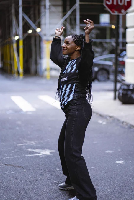 Crystal Dunn dancing while wearing her Gotham FC jersey.