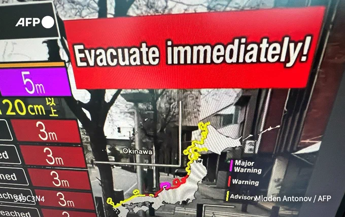 A warning message on a screen from a live feed on NHK World asking people to evacuate from the area after a series of major earthquakes hit central Japan.