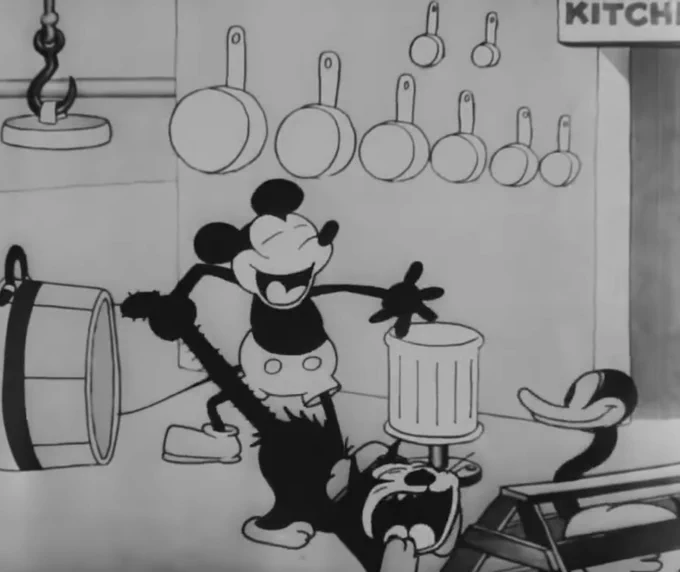 Mickey Mouse yoinking a cat’s tail and having a good old laugh about it in Steamboat Willie