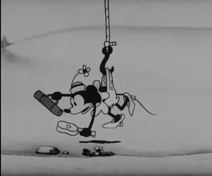 Mickey Mouse lifting Minnie Mouse up with a big hook stuck in her underpants. He’s probably laughing about it but we can’t see because he’s out of shot.