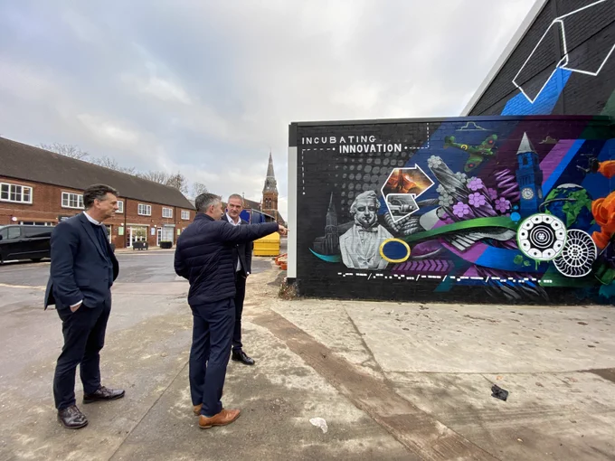 The group tour a new mural that has been painted on site 