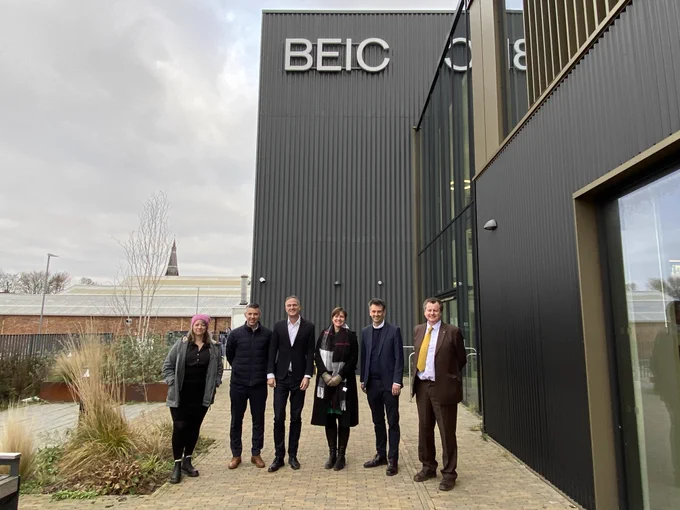 Peter Kyle MP and hosts stand outside the Birmingham Energy Innovation Centre 