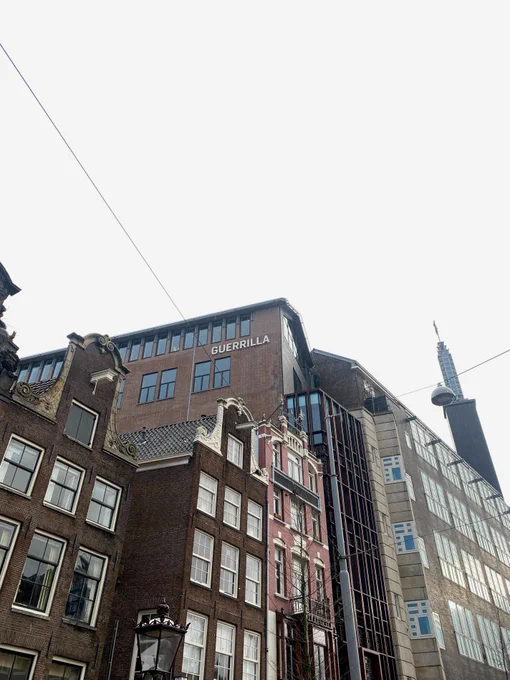View of the Guerrilla building (with "Guerrilla" written on the side) in between Amsterdam buildings