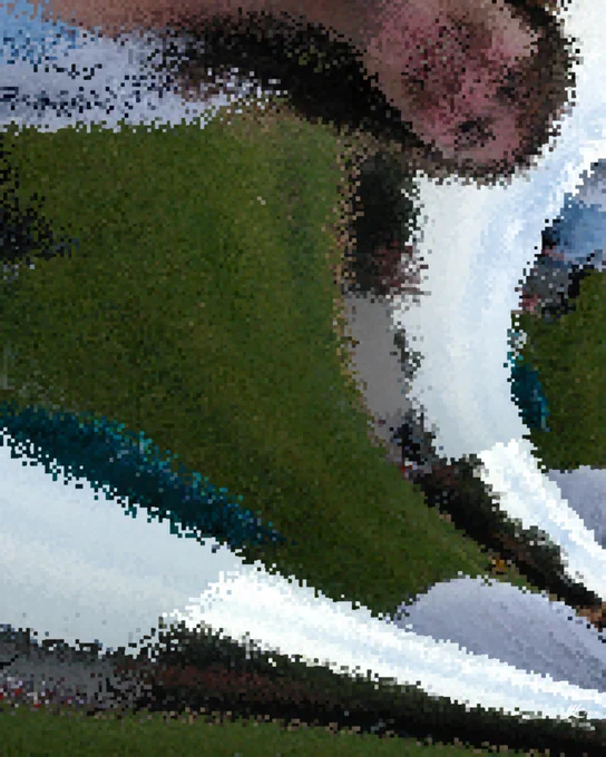 A highly pixelated and mutated picture of a woman on a soccer field. She peers down from the top of the image across three arcs of the sky and grass that curve down to the bottom right.