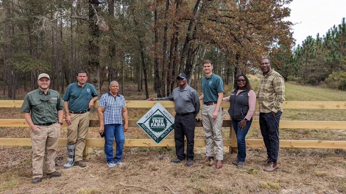 Conservation partners with Herbert and Sandra Hodges (center) in front of their new Certified Tree Farm sign. Left to right: Owen Jenkins, wildlife biologist with the Georgia Dept of Natural Resources; Doug Claxton, chief ranger with the Georgia Forestry Commission; Sandra Hodges; Herbert Hodges; Matt O’Connor, management forester with the Georgia Forestry Commission; Vontice Jackson, district conservationist for the NRCS; Luther Jones, Longleaf for All NRCS liaison. Photo courtesy of Tiffany Woods, National Wildlife Federation.