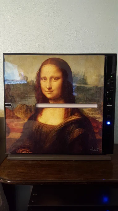 A MinusA2 air purifier showcasing a retired 'Mona Lisa' front panel design, set on a wooden stand in a room.