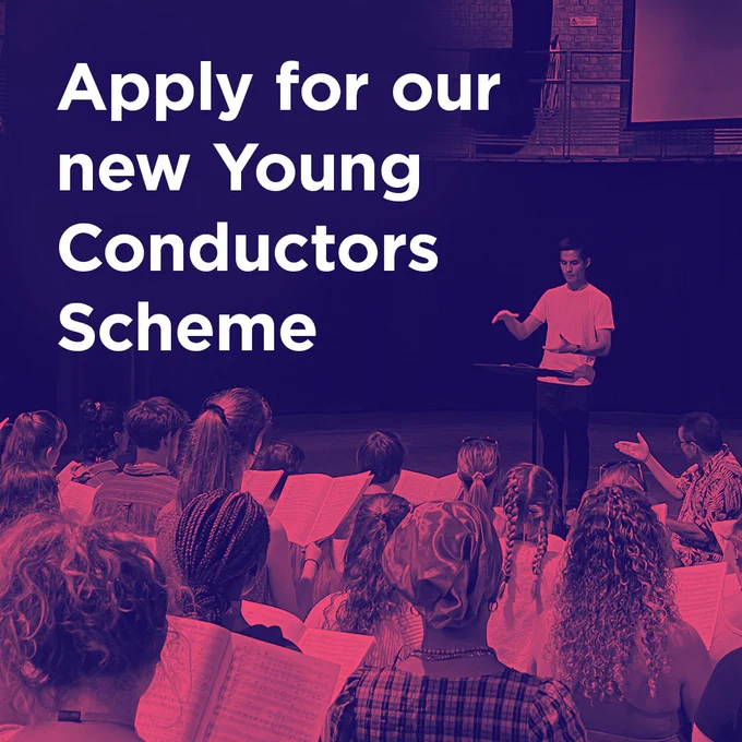 An Asian man leads a rehearsal on a stage in front of a large youth choir. Text: Apply for our New Conductors Scheme