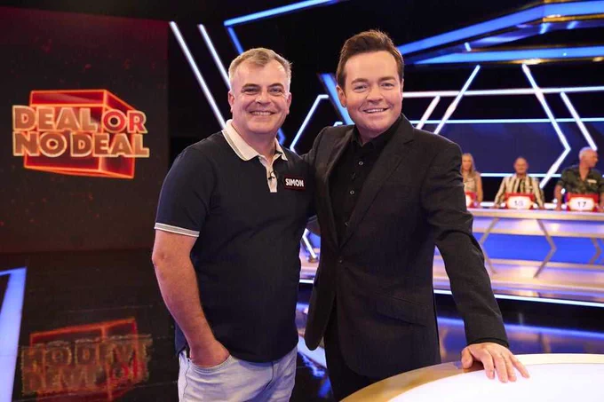 Simon Gregson and Stephen Mulhern smiling in the ITV Deal or No Deal studio.