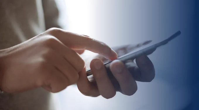 Person holding mobile phone 