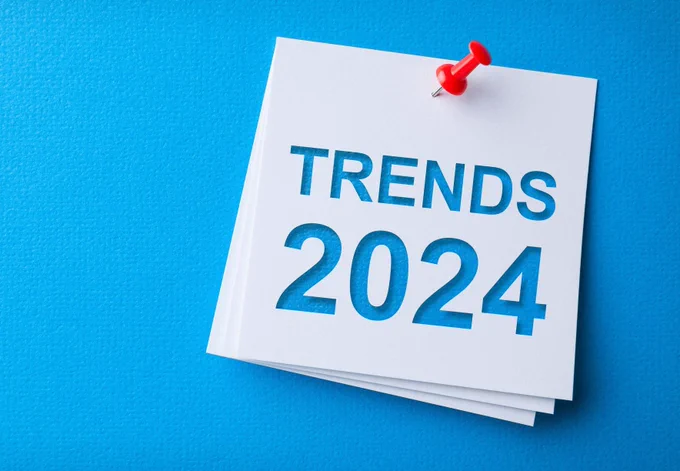 Blue background. Post it note labelled with words, 'Trends 2024'