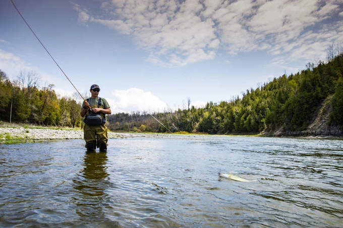 Person fishing in a stream in Ontario. 